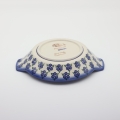 Round baking dish with handles made of Boleslawiec pottery.