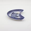 Hand-decorated Bolesławiec pottery – crescent tray, elegant table decoration.