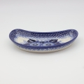 Hand-decorated Bolesławiec pottery – crescent tray, elegant table decoration.