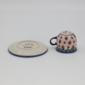 Boleslawiec espresso cup with saucer on table – traditional Polish tableware.