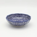 Add a touch of floral elegance to your table with the flower-shaped bowl. This unique piece from Bolesławiec stands out with its scalloped edges resembling delicate petals and intricate, hand-painted patterns.