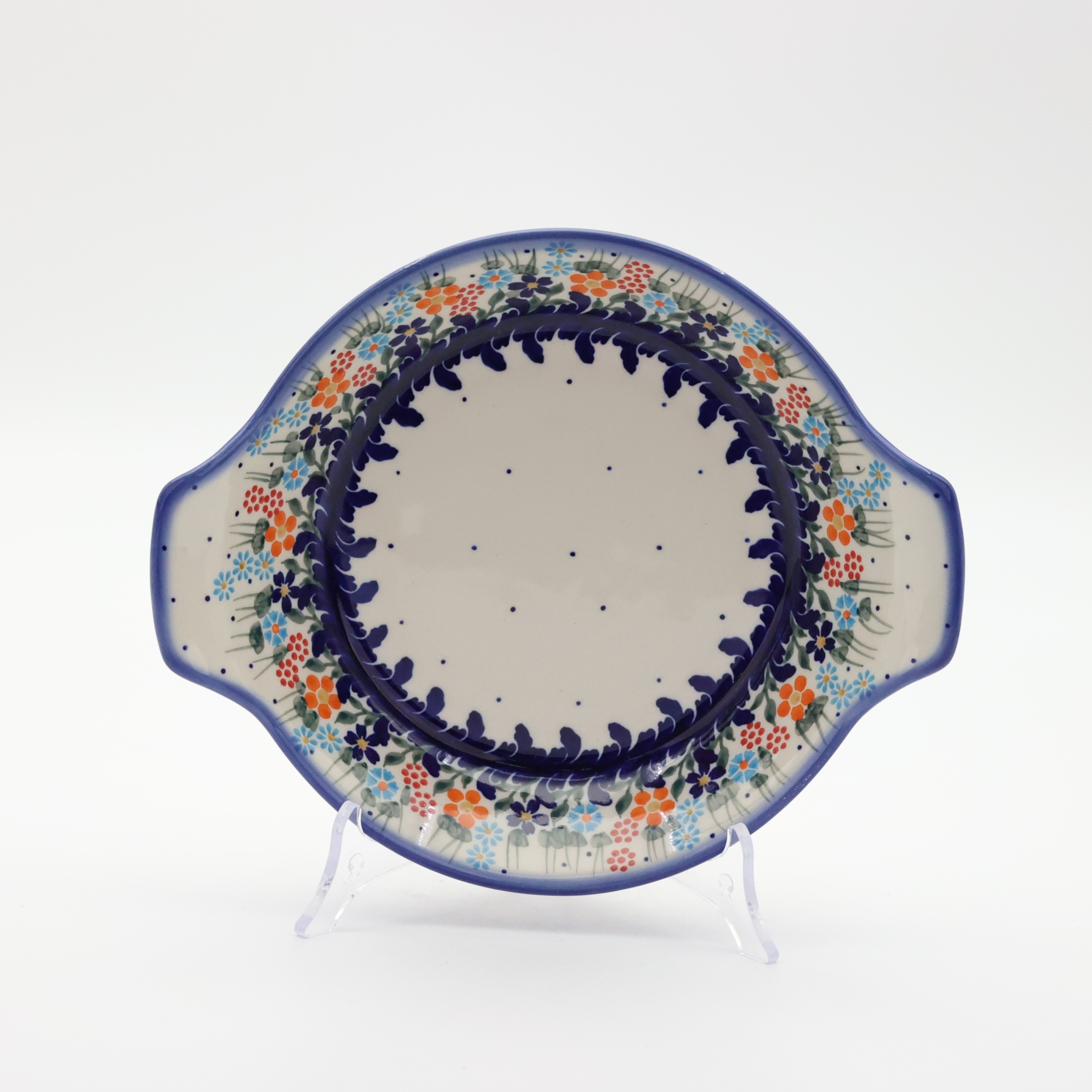 Round baking dish with handles made of Boleslawiec pottery.