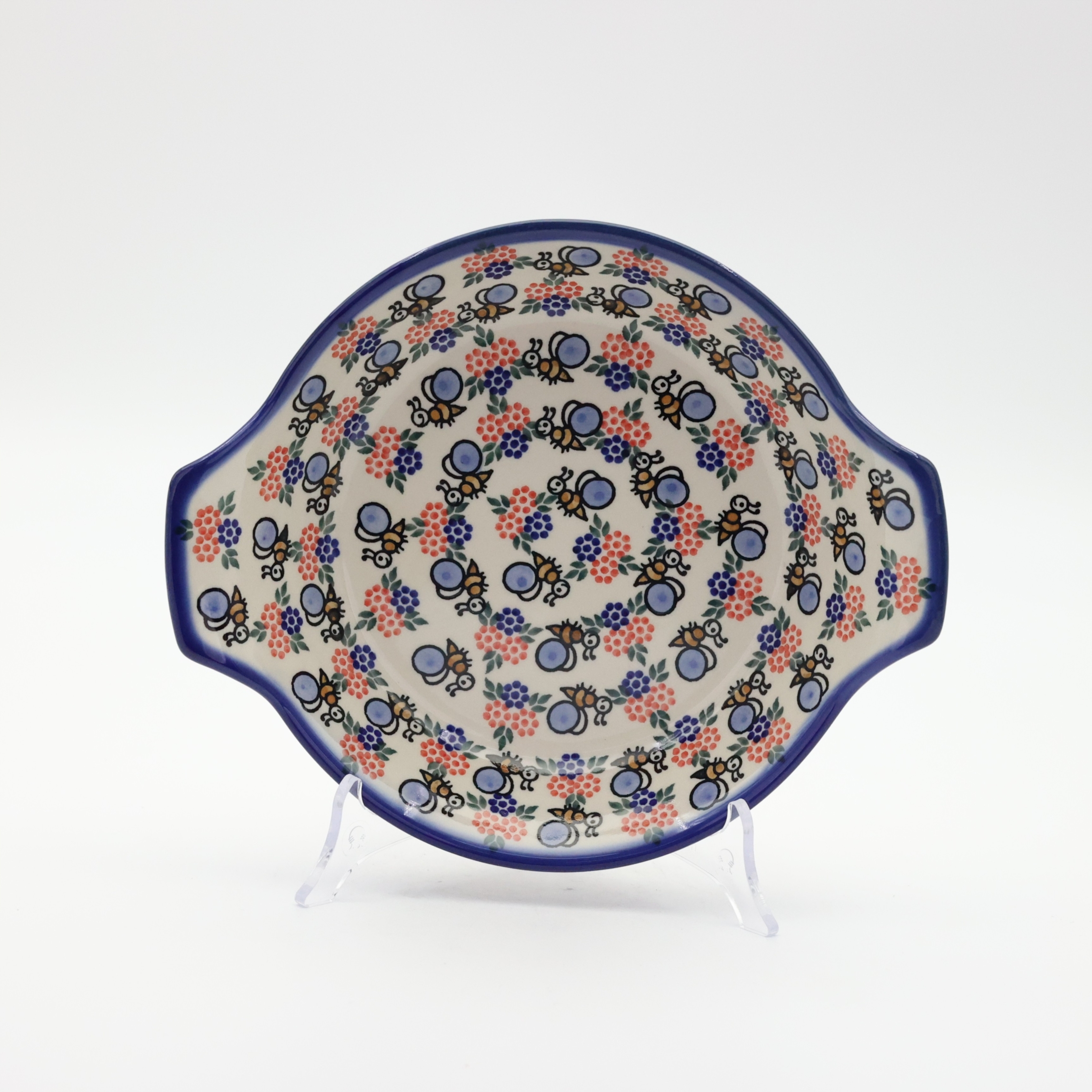Round baking dish with handles made of Boleslawiec pottery.