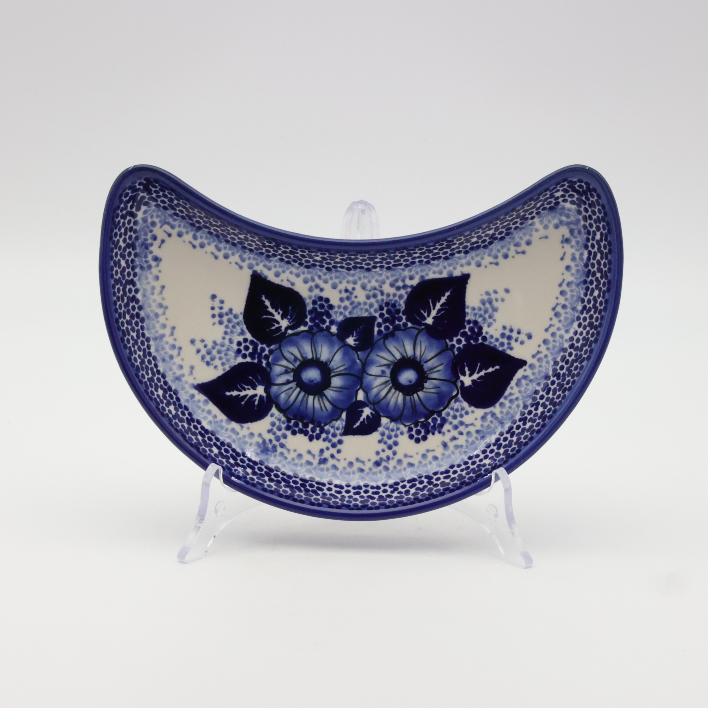 Hand-decorated Bolesławiec pottery – crescent tray, elegant table decoration.
