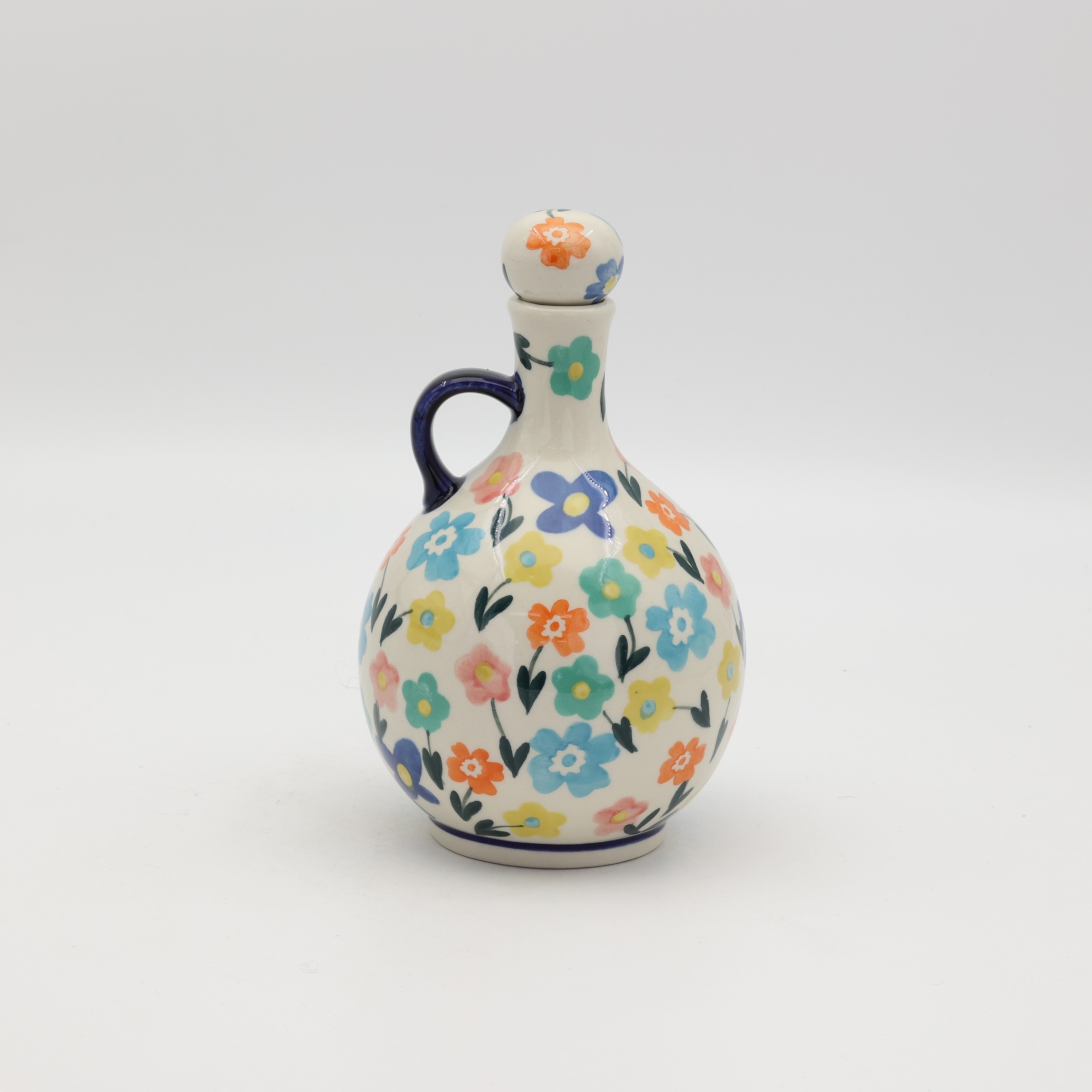 Hand-painted round decanter made from traditional Bolesławiec pottery. Unique ceramic bottle perfect for serving liqueurs, water, or as a table decoration.